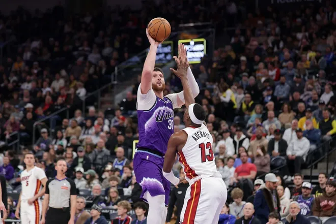 Jan 24, 2026; Salt Lake City, Utah, USA; Utah Jazz center Jusuf Nurkić (30) shoots the ball over Miami Heat center/forward Bam Adebayo (13) during the second half at Delta Center.