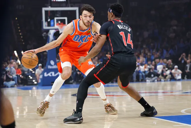 Jan 25, 2026; Oklahoma City, Oklahoma, USA; Oklahoma City Thunder center/forward Chet Holmgren (7) moves the ball down the court as Toronto Raptors guard Ja'kobe Walter (14) defends during the first quarter at Paycom Center. Mandatory Credit: Alonzo Adams-Imagn Images