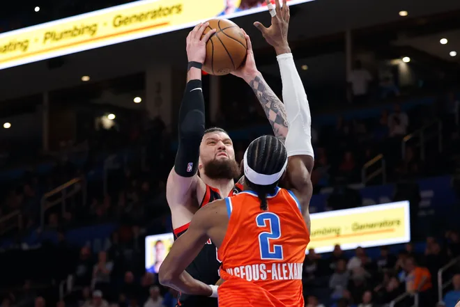 Jan 25, 2026; Oklahoma City, Oklahoma, USA; Toronto Raptors forward/center Sandro Mamukelashvili (54) shoots as Oklahoma City Thunder guard Shai Gilgeous-Alexander (2) defends during the second half at Paycom Center. Mandatory Credit: Alonzo Adams-Imagn Images