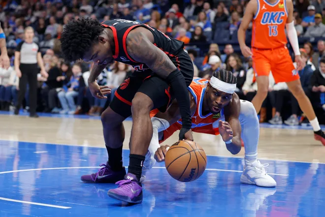 Jan 25, 2026; Oklahoma City, Oklahoma, USA; Toronto Raptors guard Jamal Shead (23) and Oklahoma City Thunder guard Shai Gilgeous-Alexander (2) fight for a loose ball during the second half at Paycom Center. Mandatory Credit: Alonzo Adams-Imagn Images