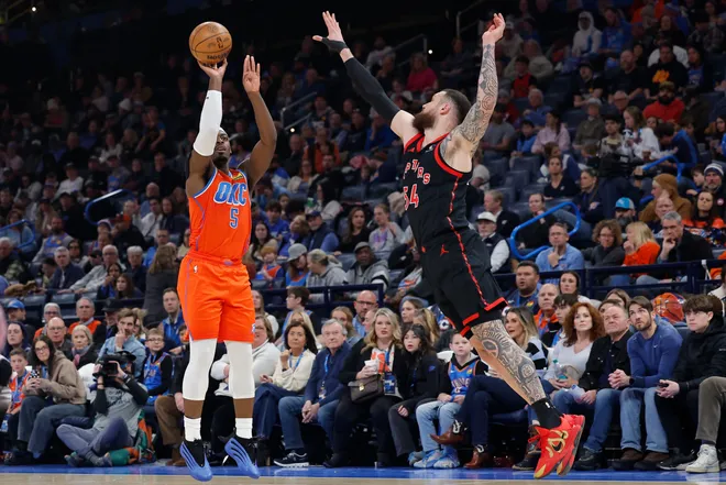 Jan 25, 2026; Oklahoma City, Oklahoma, USA; Oklahoma City Thunder guard Luguentz Dort (5) shoots a three point basket as Toronto Raptors forward/center Sandro Mamukelashvili (54) defends during the second quarter at Paycom Center. Mandatory Credit: Alonzo Adams-Imagn Images