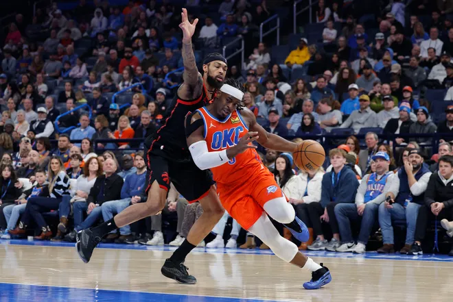 Jan 25, 2026; Oklahoma City, Oklahoma, USA; Oklahoma City Thunder guard Luguentz Dort (5) drives to the basket as Toronto Raptors forward Brandon Ingram (3) defends during the second quarter at Paycom Center. Mandatory Credit: Alonzo Adams-Imagn Images