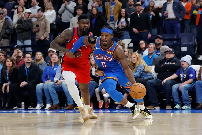 Jan 27, 2026; Oklahoma City, Oklahoma, USA; Oklahoma City Thunder guard Luguentz Dort (5) drives to the basket around New Orleans Pelicans forward Zion Williamson (1) during the second half at Paycom Center. Mandatory Credit: Alonzo Adams-Imagn Images