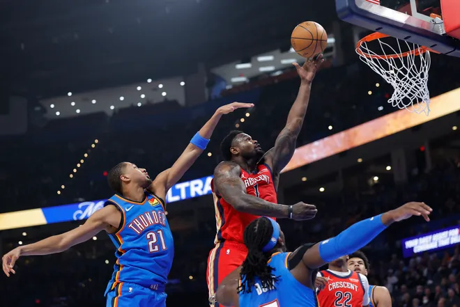 Jan 27, 2026; Oklahoma City, Oklahoma, USA; New Orleans Pelicans forward Zion Williamson (1) goes up for a basket between Oklahoma City Thunder guard Aaron Wiggins (21) and guard Luguentz Dort (5) during the second quarter at Paycom Center. Mandatory Credit: Alonzo Adams-Imagn Images