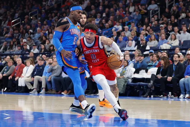 Jan 27, 2026; Oklahoma City, Oklahoma, USA; New Orleans Pelicans guard Jeremiah Fears (0) drives past Oklahoma City Thunder guard Luguentz Dort (5) during the second quarter at Paycom Center. Mandatory Credit: Alonzo Adams-Imagn Images