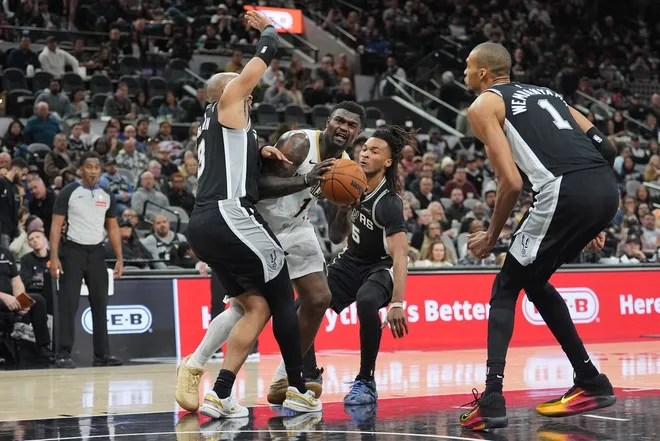 Jan 25, 2026; San Antonio, Texas, USA; New Orleans Pelicans forward Zion Williamson (1) drives in between San Antonio Spurs forward Keldon Johnson (3), guard Stephon Castle (5), and forward Victor Wembanyama (1) in the second half at Frost Bank Center.