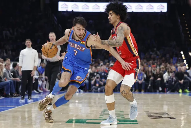 Jan 27, 2026; Oklahoma City, Oklahoma, USA; Oklahoma City Thunder center/forward Chet Holmgren (7) drives around New Orleans Pelicans guard/forward Micah Peavy (14) during the second half at Paycom Center.