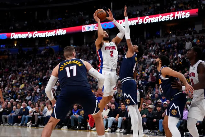 Jan 27, 2026; Denver, Colorado, USA; Detroit Pistons guard Cade Cunningham (2) drives at Denver Nuggets guard Peyton Watson (8) in the second half at Ball Arena.