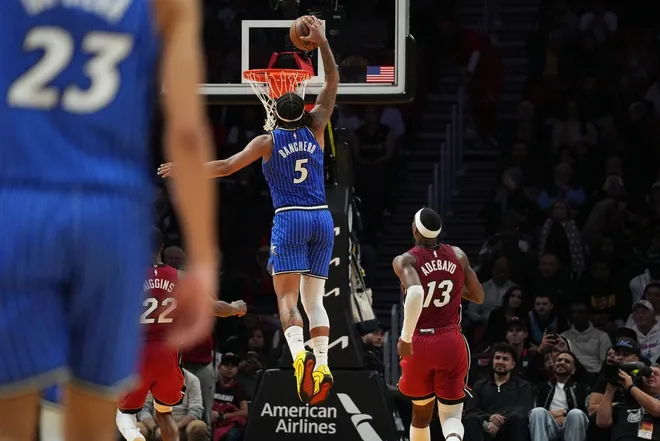 Jan 28, 2026; Miami, Florida, USA; Orlando Magic forward Paolo Banchero (5) dunks as Miami Heat center Bam Adebayo (13) follows on the play during the second half at Kaseya Center.