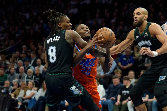 Jan 29, 2026; Minneapolis, Minnesota, USA; Oklahoma City Thunder guard Cason Wallace (22) fouled by Minnesota Timberwolves guard Bones Hyland (8) in the third quarter at Target Center. Mandatory Credit: Matt Blewett-Imagn Images