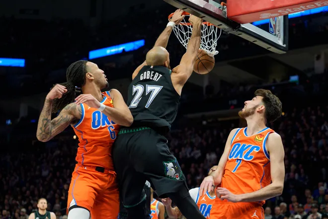 Jan 29, 2026; Minneapolis, Minnesota, USA; Minnesota Timberwolves center Rudy Gobert (27) dunks over the defense of Oklahoma City Thunder forward Jaylin Williams (6) and center Chet Holmgren (7) in the second quarter at Target Center. Mandatory Credit: Matt Blewett-Imagn Images