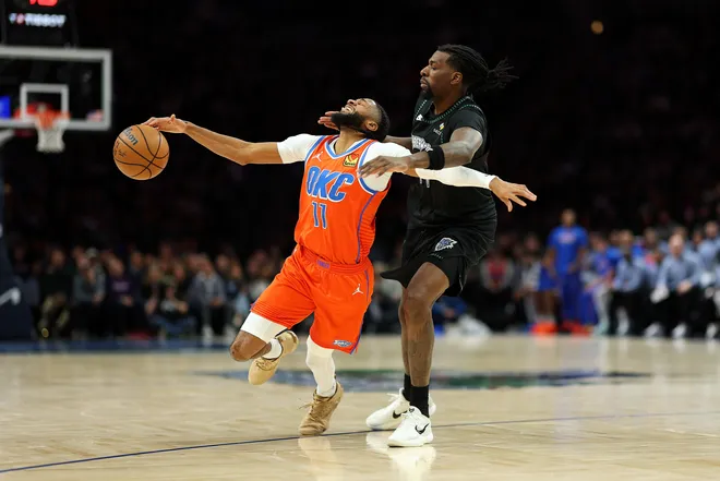 MINNEAPOLIS, MINNESOTA - JANUARY 29: Isaiah Joe #11 of the Oklahoma City Thunder draws a foul against Naz Reid #11 of the Minnesota Timberwolves in the second quarter at Target Center on January 29, 2026 in Minneapolis, Minnesota. NOTE TO USER: User expressly acknowledges and agrees that, by downloading and or using this photograph, User is consenting to the terms and conditions of the Getty Images License Agreement. (Photo by David Berding/Getty Images)