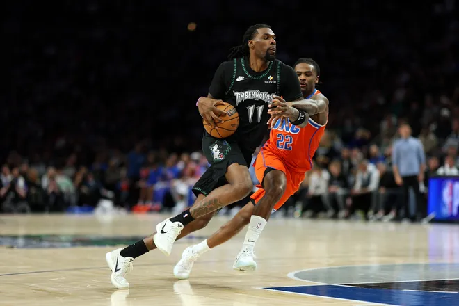 MINNEAPOLIS, MINNESOTA - JANUARY 29: Naz Reid #11 of the Minnesota Timberwolves drives to the basket against Cason Wallace #22 of the Oklahoma City Thunder in the fourth quarter at Target Center on January 29, 2026 in Minneapolis, Minnesota. The Timberwolves defeated the Thunder 123-111. NOTE TO USER: User expressly acknowledges and agrees that, by downloading and or using this photograph, User is consenting to the terms and conditions of the Getty Images License Agreement. (Photo by David Berding/Getty Images)