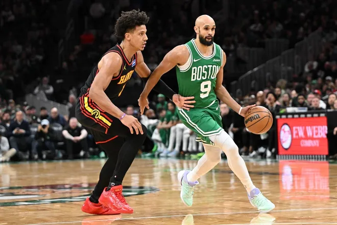 Jan 28, 2026; Boston, Massachusetts, USA; Boston Celtics guard Derrick White (9) drives to the basket against Atlanta Hawks forward Jalen Johnson (1) during the second half at the TD Garden.