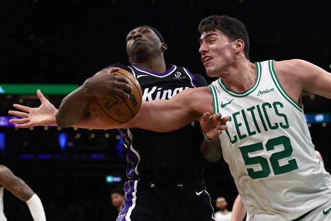 Jan 30, 2026; Boston, Massachusetts, USA; Boston Celtics center Luka Garza (52) battles Sacramento Kings guard Daeqwon Plowden (29) for the ball during the second half at TD Garden. Mandatory Credit: Winslow Townson-Imagn Images