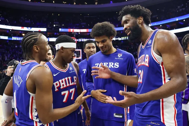 Jan 29, 2026; Philadelphia, Pennsylvania, USA; Philadelphia 76ers center Joel Embiid (21) reacts with Philadelphia 76ers guard Tyrese Maxey (L) in front of guard Vj Edgecombe (77) after a victory against the Sacramento Kings at Xfinity Mobile Arena.
