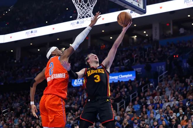 Dec 29, 2025; Oklahoma City, Oklahoma, USA; Atlanta Hawks guard Luke Kennard (3) shoots as Oklahoma City Thunder guard Shai Gilgeous-Alexander (2) defends during the first half at Paycom Center. Mandatory Credit: Alonzo Adams-Imagn Images