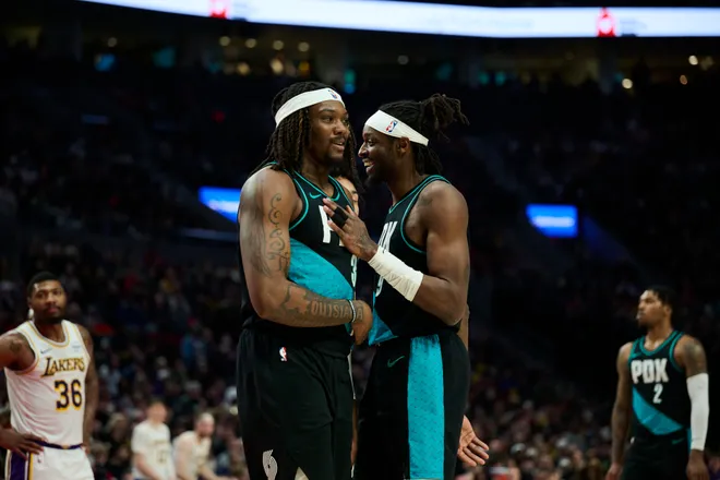 Jan 17, 2026; Portland, Oregon, USA; Portland Trail Blazers forward Jerami Grant (9) gives center Robert Williams III (35) a pat on the chest during the first half against the Los Angeles Lakers at Moda Center. Mandatory Credit: Troy Wayrynen-Imagn Images