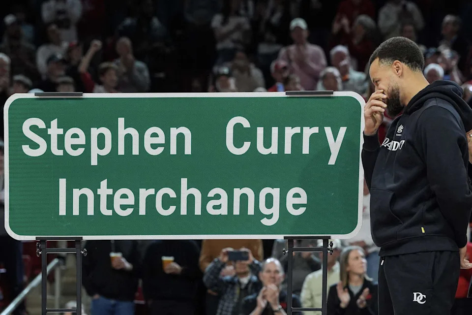 Golden State Warriors guard and Davidson alumni Stephen Curry reacts to seeing the sign for ‘Stephen Curry Interchange’ during halftime of a college basketball game between Davidson and Duquesne on Dec. 30, 2025, in Davidson.