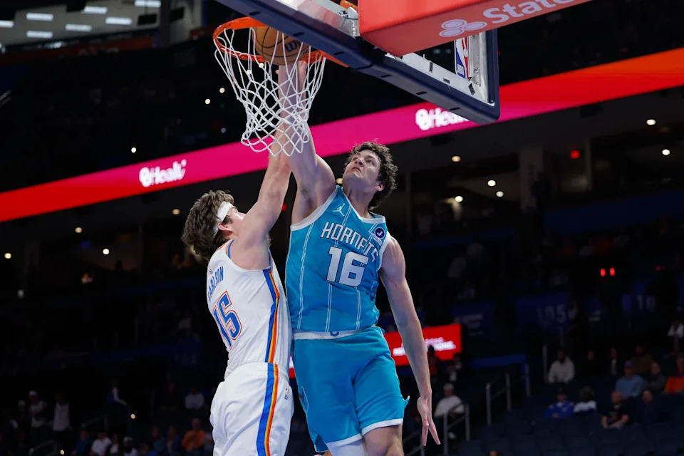 Jan 5, 2026; Oklahoma City, Oklahoma, USA; Charlotte Hornets center PJ Hall (16) dunks beside Oklahoma City Thunder center Branden Carlson (15) during the second half at Paycom Center. Mandatory Credit: Alonzo Adams-Imagn Images