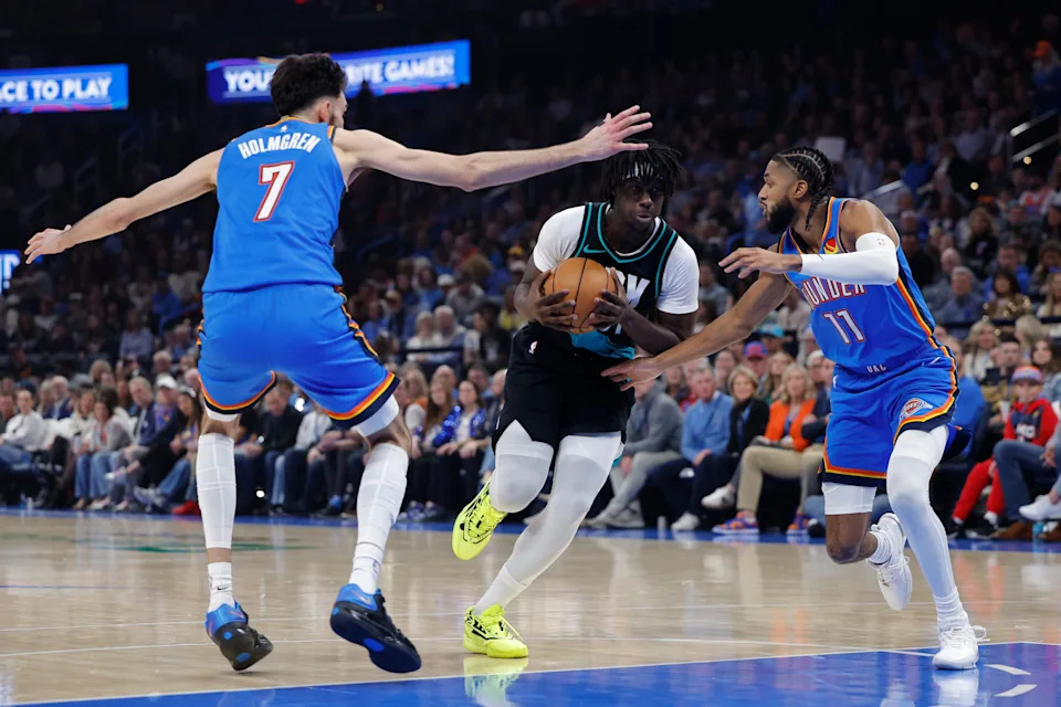 Dec 31, 2025; Oklahoma City, Oklahoma, USA; Portland Trail Blazers guard Sidy Cissoko (91) drives between Oklahoma City Thunder center Chet Holmgren (7) and guard Isaiah Joe (11) during the second quarter at Paycom Center. Mandatory Credit: Alonzo Adams-Imagn Images