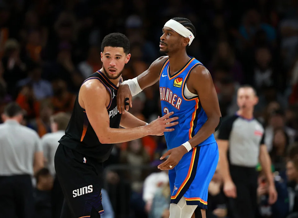 Jan 4, 2026; Phoenix, Arizona, USA; Phoenix Suns guard Devin Booker (1) against Oklahoma City Thunder guard Shai Gilgeous-Alexander (2) in the second half at Mortgage Matchup Center. Mandatory Credit: Mark J. Rebilas-Imagn Images