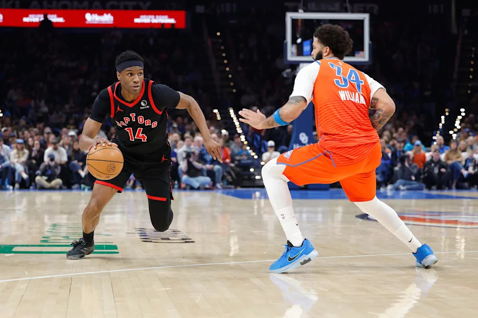 Jan 25, 2026; Oklahoma City, Oklahoma, USA; Toronto Raptors guard Ja'kobe Walter (14) drives down the court as Oklahoma City Thunder guard/forward Kenrich Williams (34) defends during the second half at Paycom Center. Mandatory Credit: Alonzo Adams-Imagn Images