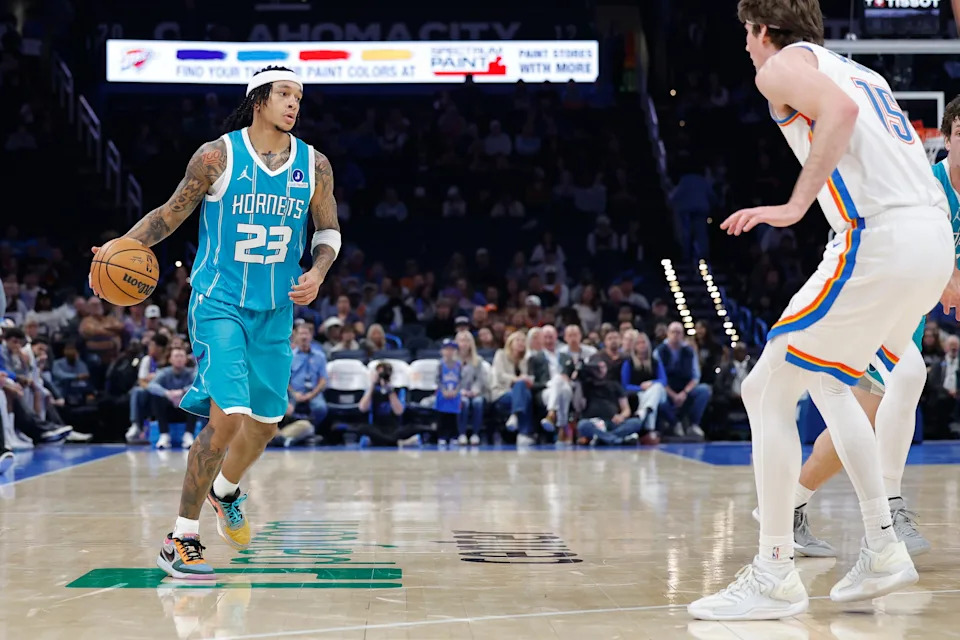 Jan 5, 2026; Oklahoma City, Oklahoma, USA; Charlotte Hornets guard Tre Mann (23) moves the ball down the court against Oklahoma City Thunder center Branden Carlson (15) during the second half at Paycom Center. Mandatory Credit: Alonzo Adams-Imagn Images