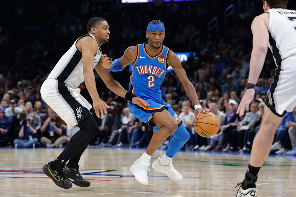 Jan 13, 2026; Oklahoma City, Oklahoma, USA; Oklahoma City Thunder guard Shai Gilgeous-Alexander (2) drives down the court past San Antonio Spurs forward/guard Keldon Johnson (3) during the second half at Paycom Center. Mandatory Credit: Alonzo Adams-Imagn Images