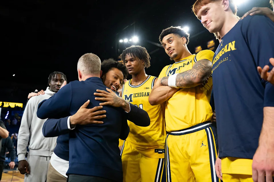 Former Wolverine Trey Burke hugs Michigan coach Dusty May following the game against the Ohio State Buckeyes as Crisler Center in Ann Arbor on Friday, Jan. 23, 2026.
