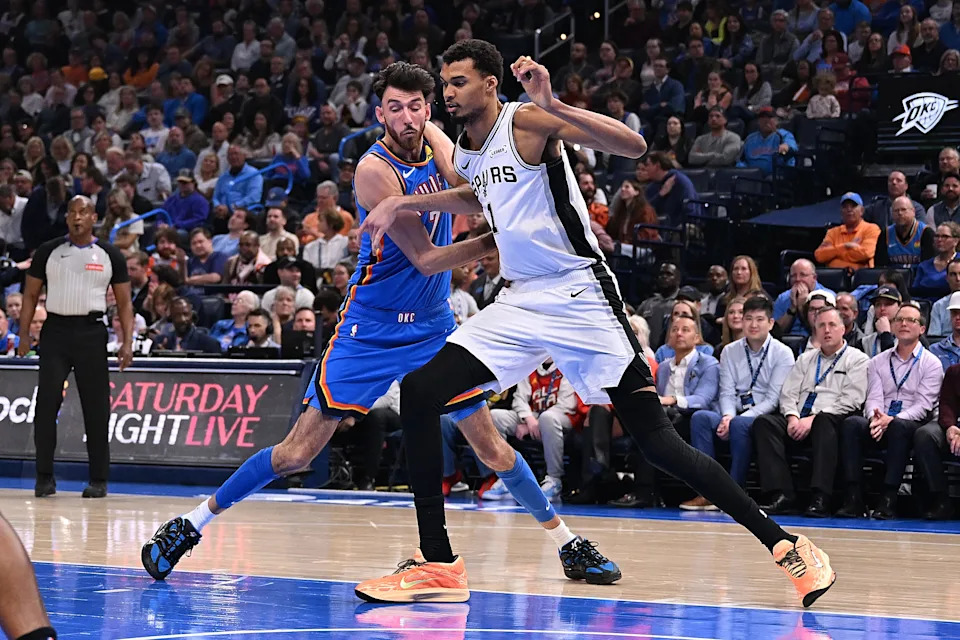 OKLAHOMA CITY, OKLAHOMA - JANUARY 13: Chet Holmgren #7 of the Oklahoma City Thunder and Victor Wembanyama #1 of the San Antonio Spurs battle for a rebound during the first half at Paycom Center on January 13, 2026 in Oklahoma City, Oklahoma. NOTE TO USER: User expressly acknowledges and agrees that, by downloading and or using this photograph, User is consenting to the terms and conditions of the Getty Images License Agreement. (Photo by Joshua Gateley/Getty Images)