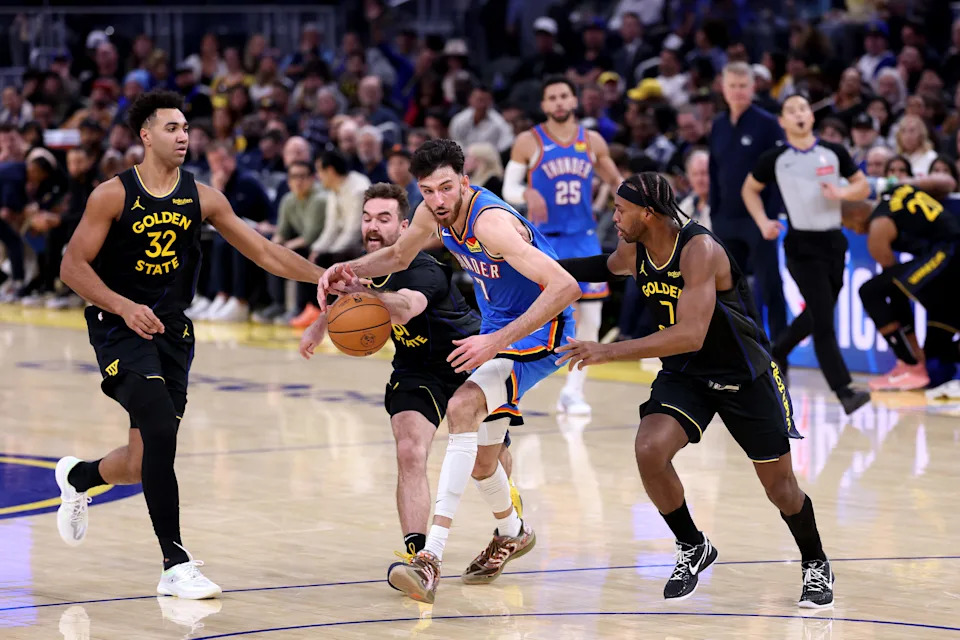 SAN FRANCISCO, CALIFORNIA - JANUARY 02: Chet Holmgren #7 of the Oklahoma City Thunder tries to dribble past Trayce Jackson-Davis #32, Pat Spencer #61 and Buddy Hield #7 of the Golden State Warriors during the second half at Chase Center on January 02, 2026 in San Francisco, California. NOTE TO USER: User expressly acknowledges and agrees that, by downloading and/or using this photograph, user is consenting to the terms and conditions of the Getty Images License Agreement. (Photo by Ezra Shaw/Getty Images)