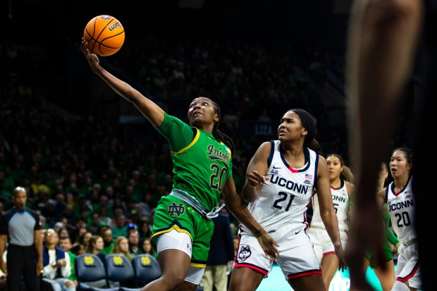 Notre Dame forward Liatu King (20) grabs a rebound as UConn forward Sarah Strong (21) defends during the second half of an NCAA college basketball game Thursday, Dec. 12, 2024, in South Bend, Ind. (AP Photo/Michael Caterina)