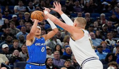 Orlando Magic guard Anthony Black (0) shoots over Denver Nuggets center Nikola Jokic during the first half of an NBA basketball game, Saturday, Dec. 27, 2025, in Orlando, Fla. (AP Photo/John Raoux)