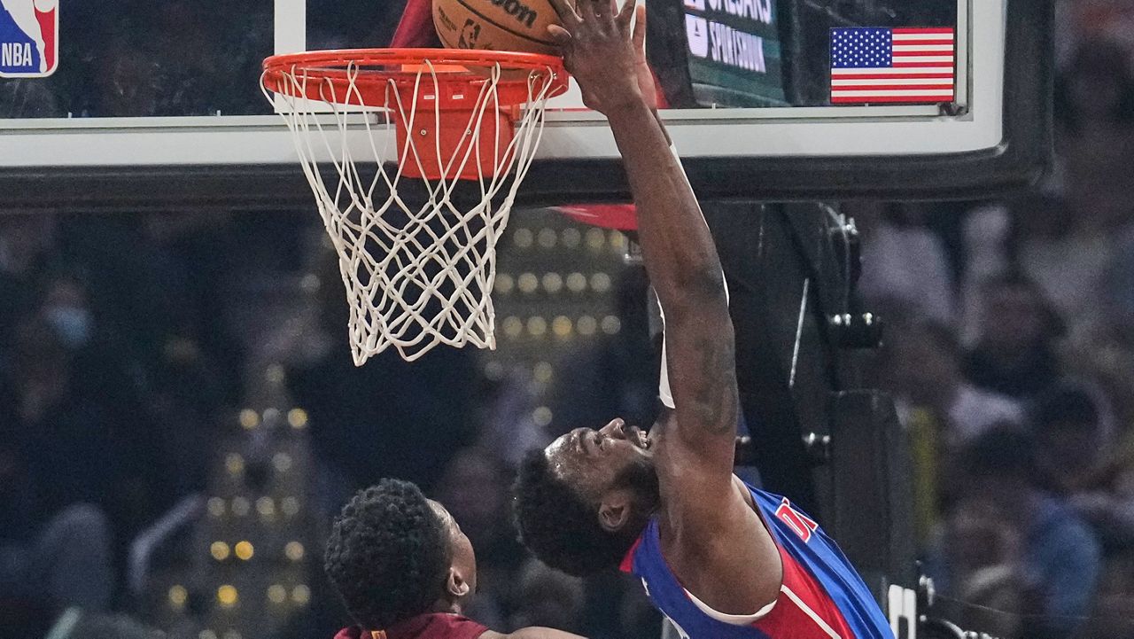 Detroit Pistons forward Paul Reed, right, dunks in front of Cleveland Cavaliers center Thomas Bryant, left, in the first half of an NBA basketball game Sunday, Jan. 4, 2026, in Cleveland. (AP Photo/Sue Ogrocki)