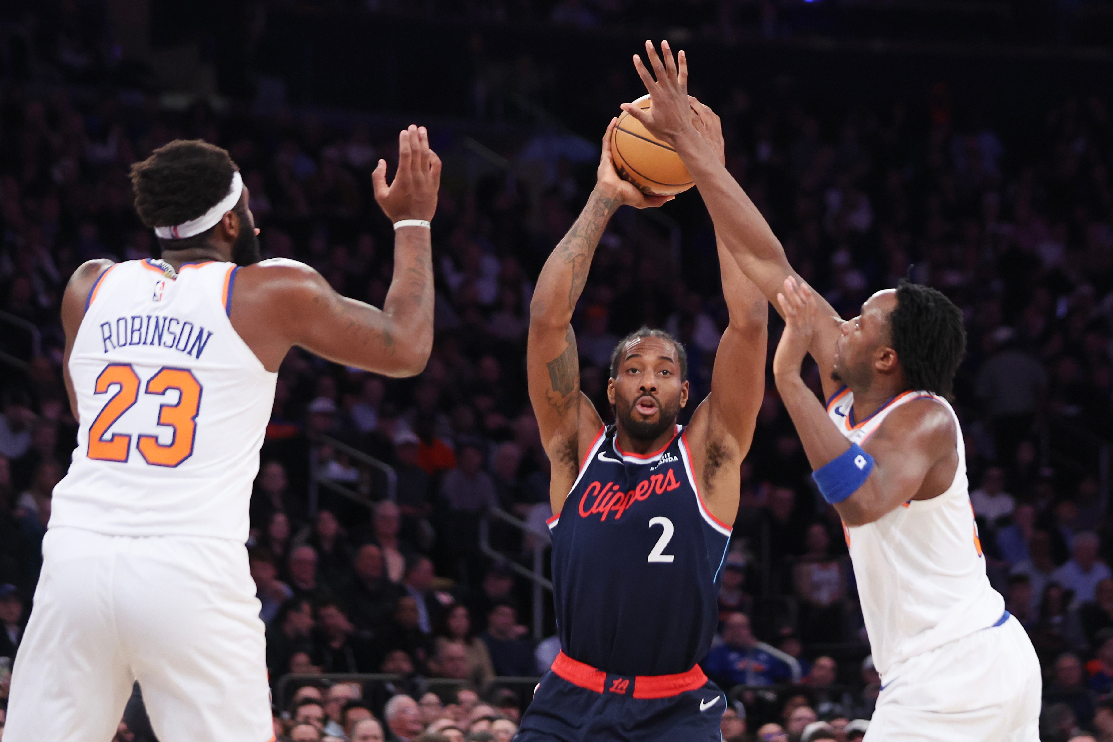 Clippers star Kawhi Leonard looks to pass the ball as...