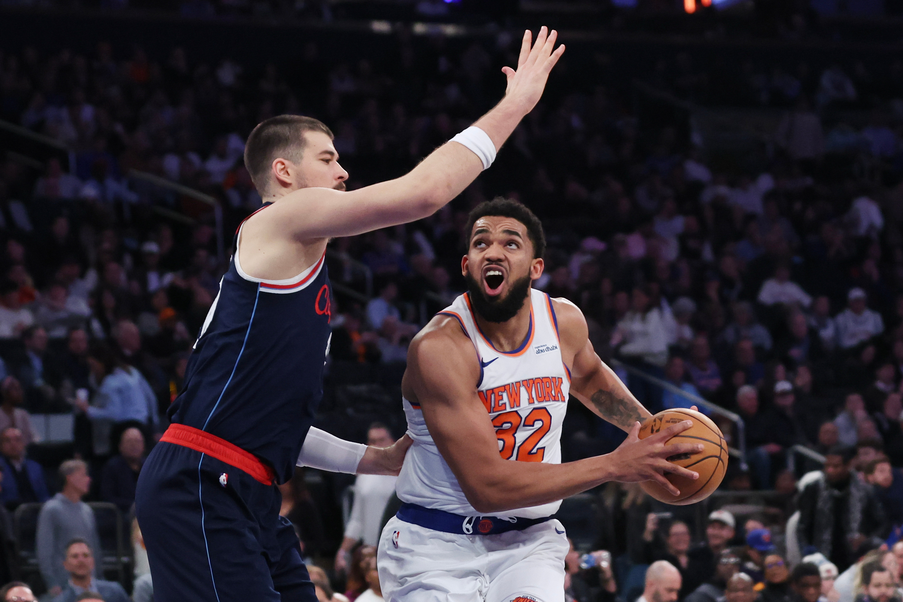 New York Knicks center Karl-Anthony Towns drives to the basket...