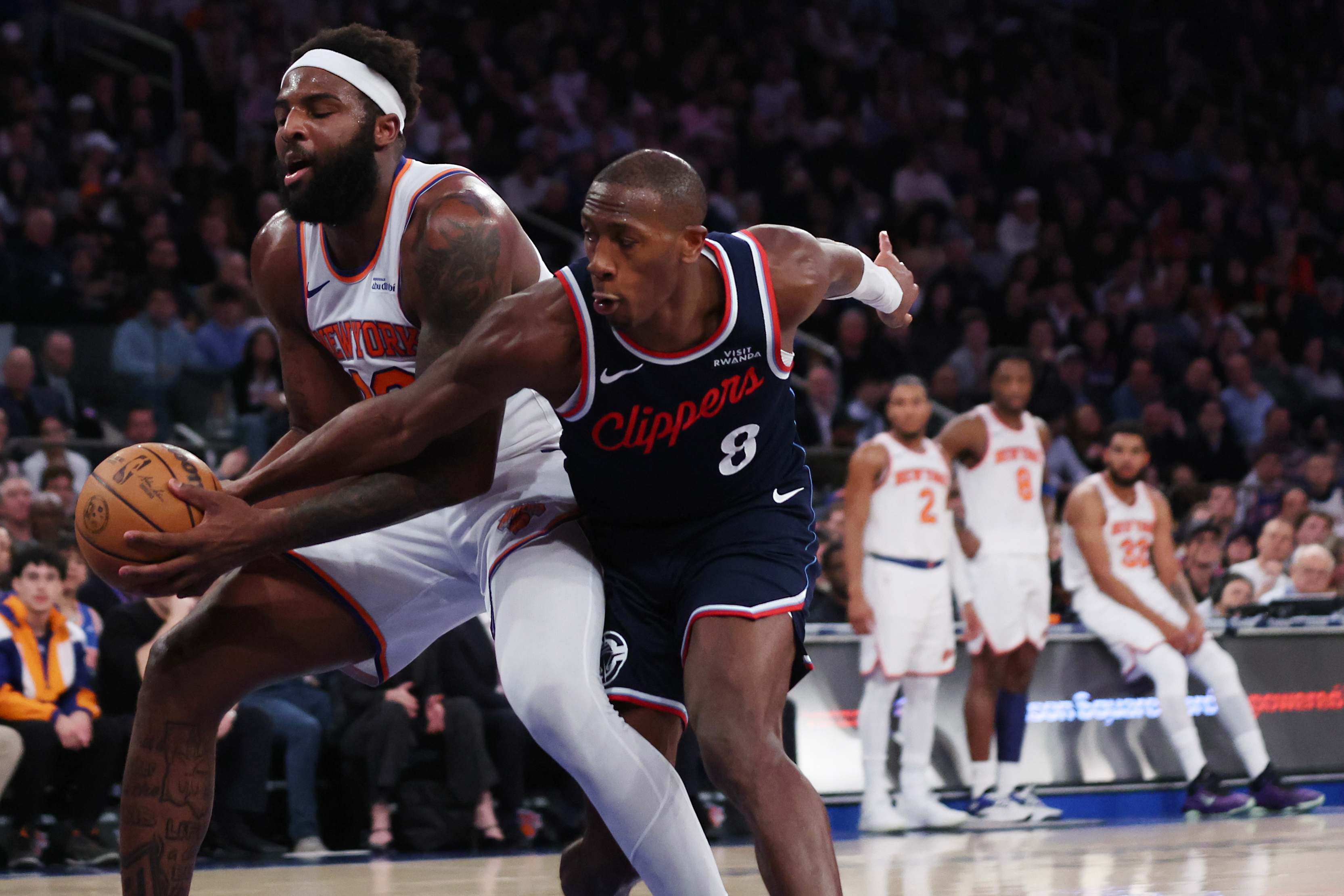 Clippers guard Kris Dunn, right, and New York Knicks center...
