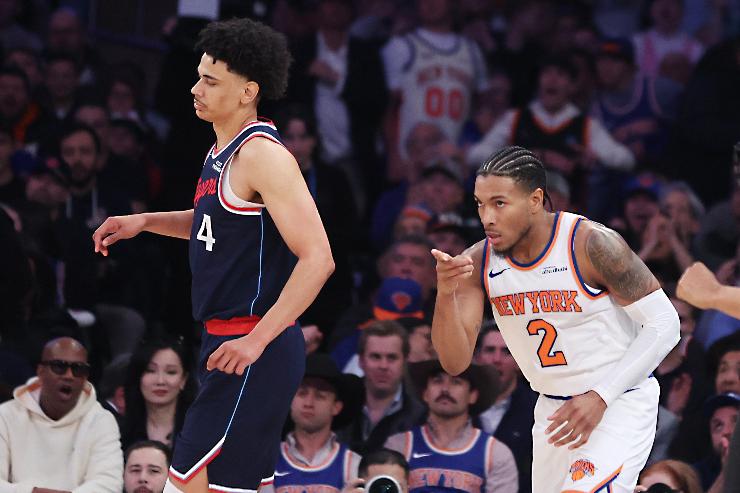 New York Knicks guard Miles McBride, right, points to a...