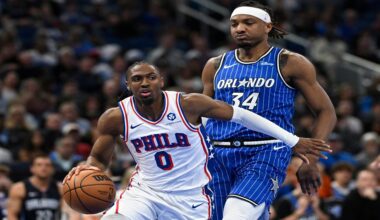 Philadelphia 76ers guard Tyrese Maxey (0) drives to the basket past Orlando Magic center Wendell Carter Jr. (34) during the first half of an NBA basketball game, Friday, Jan. 9, 2026, in Orlando, Fla. (AP Photo/Phelan M. Ebenhack)
