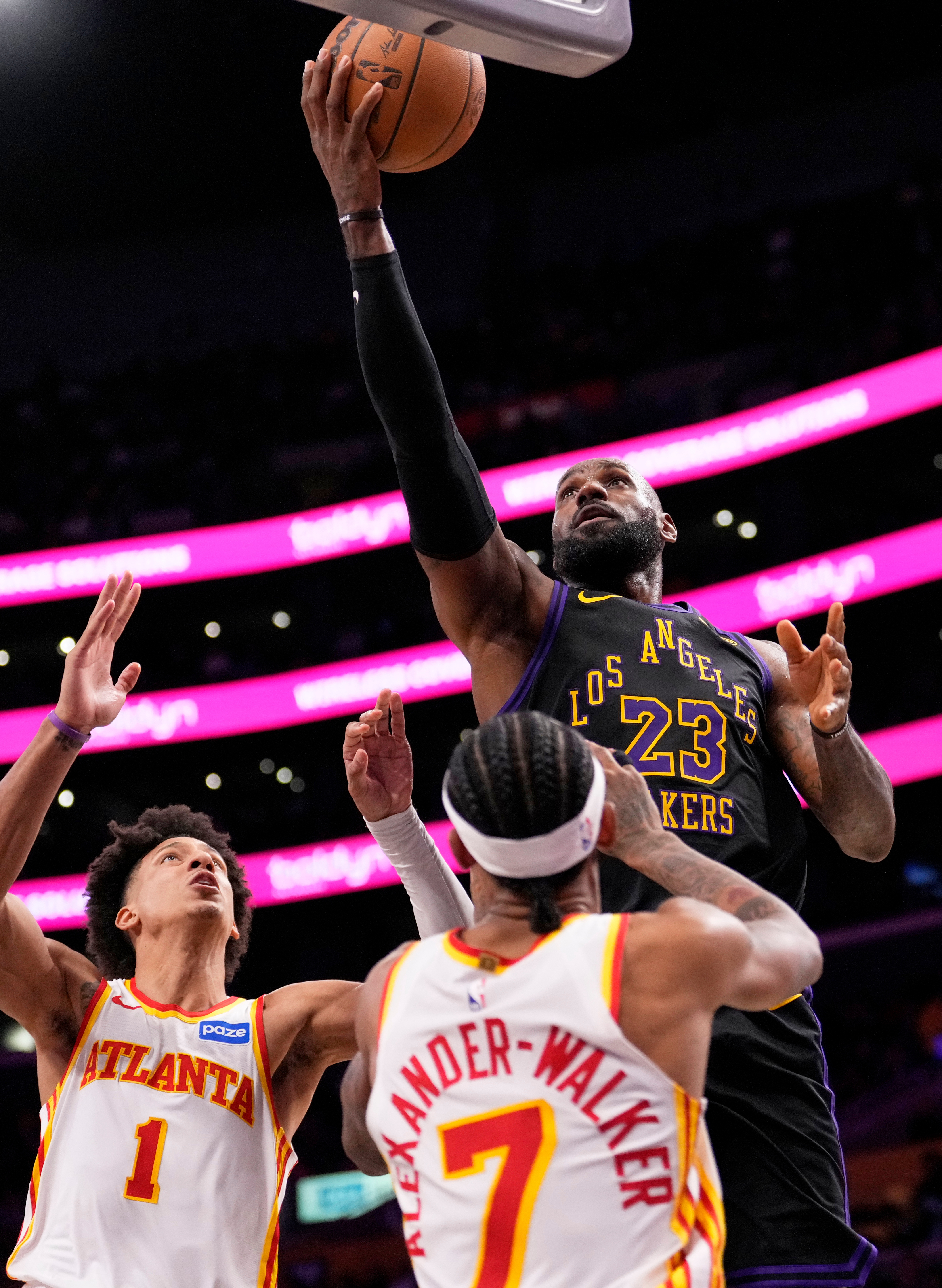 Lakers forward LeBron James, right, shoots as Atlanta Hawks forward...