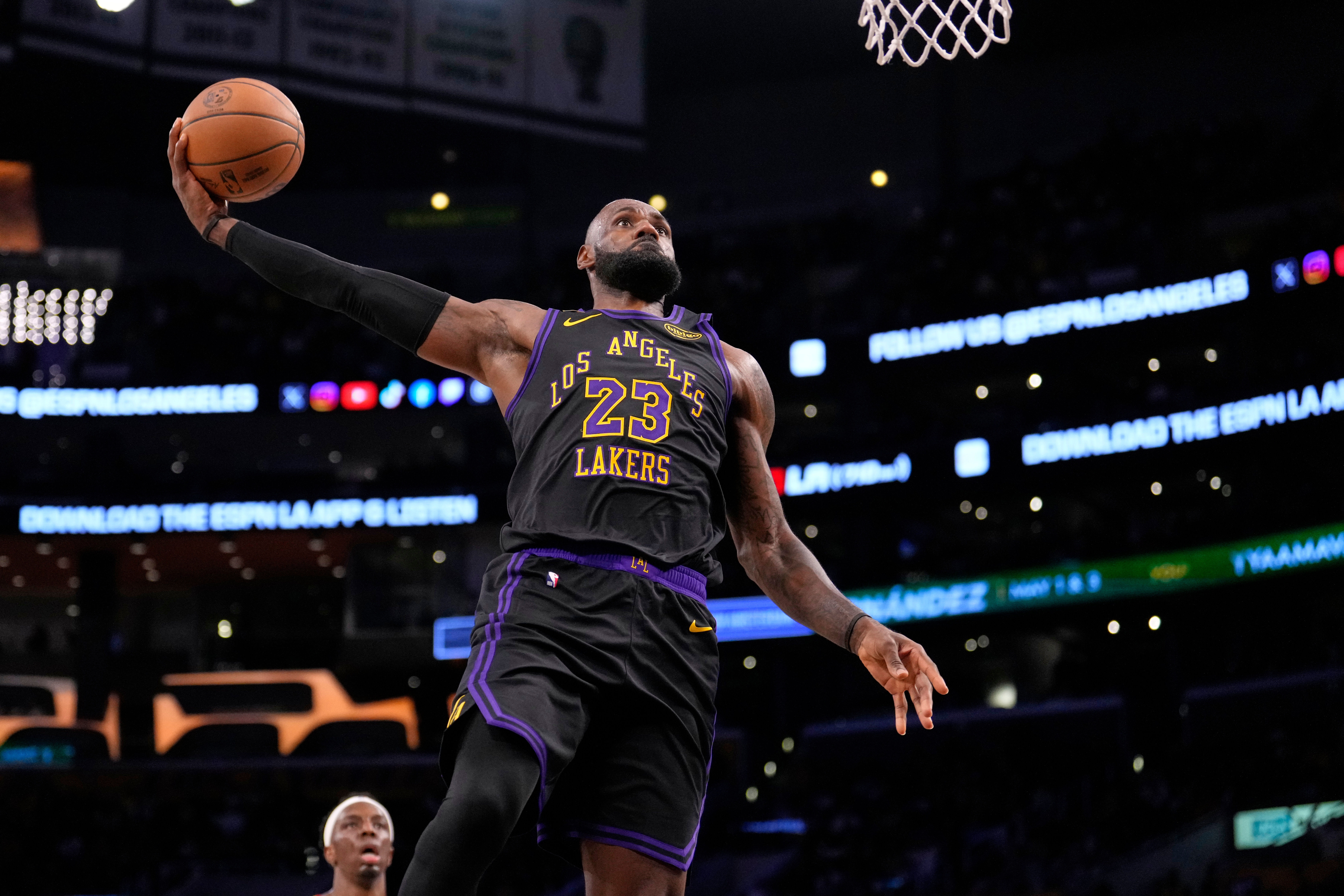 Lakers forward LeBron James soars to the basket for a...