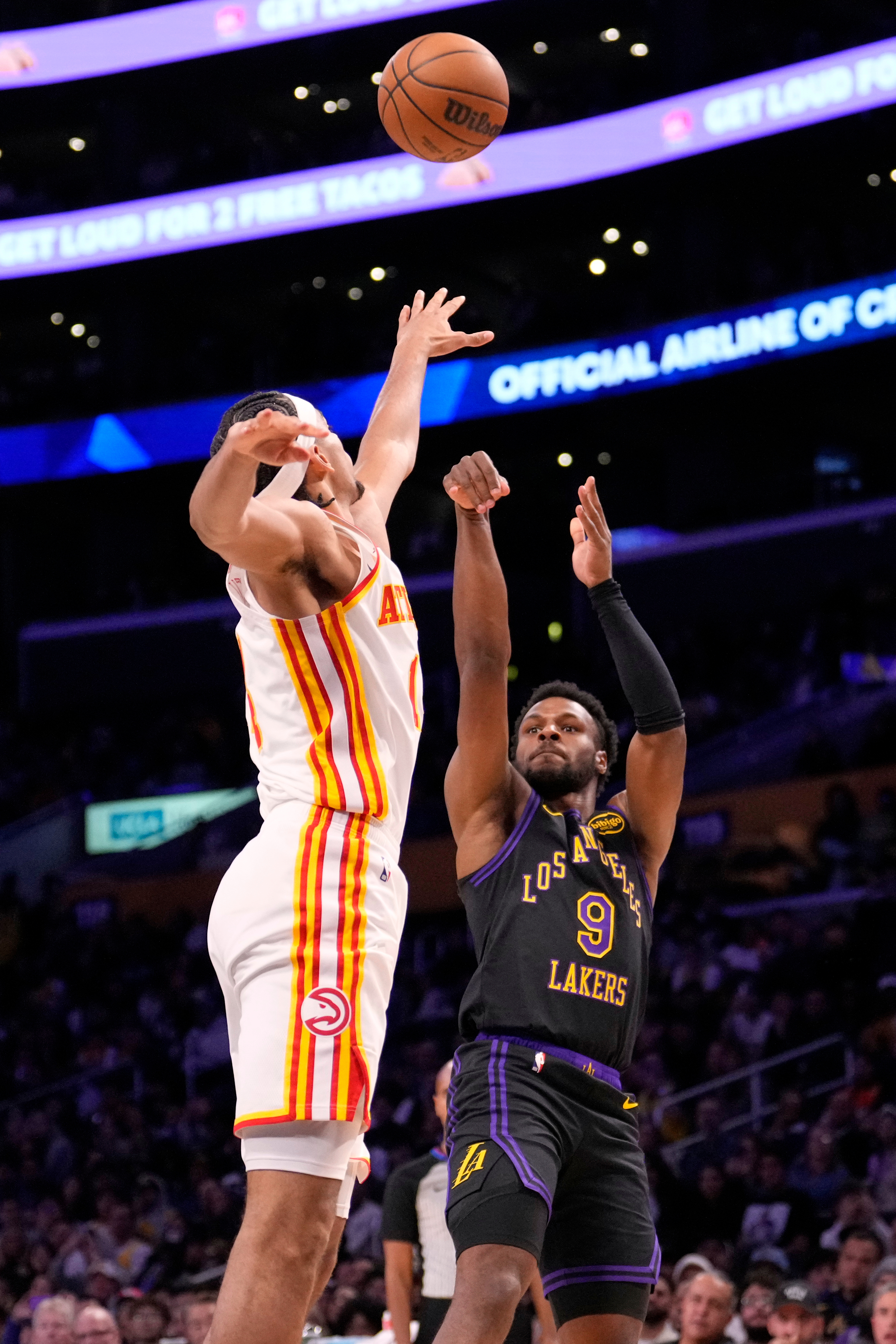 Lakers guard Bronny James, right, shoots as Atlanta Hawks forward...