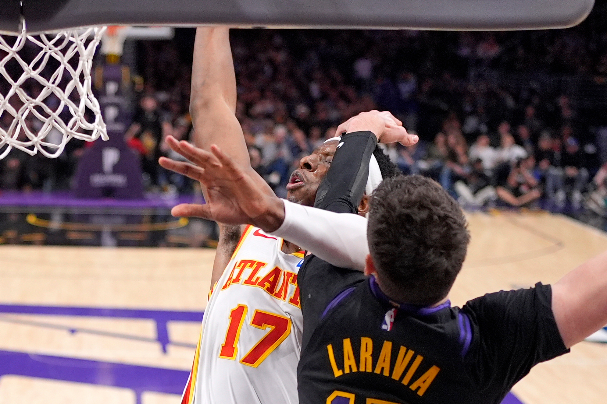 Atlanta Hawks forward Onyeka Okongwu, left, is hit in the...