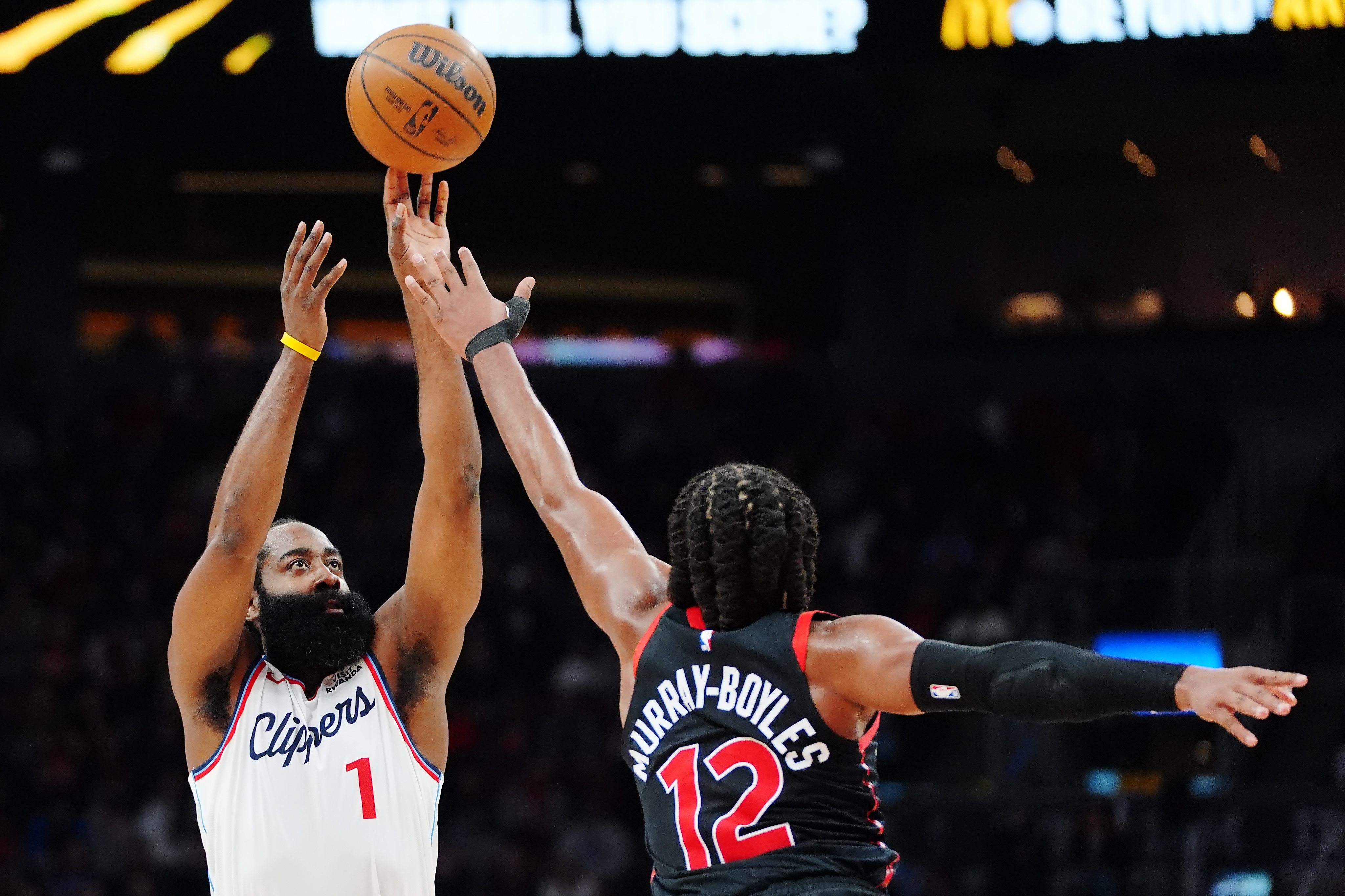 Clippers star James Harden shoots as the Toronto Raptors’ Collin...