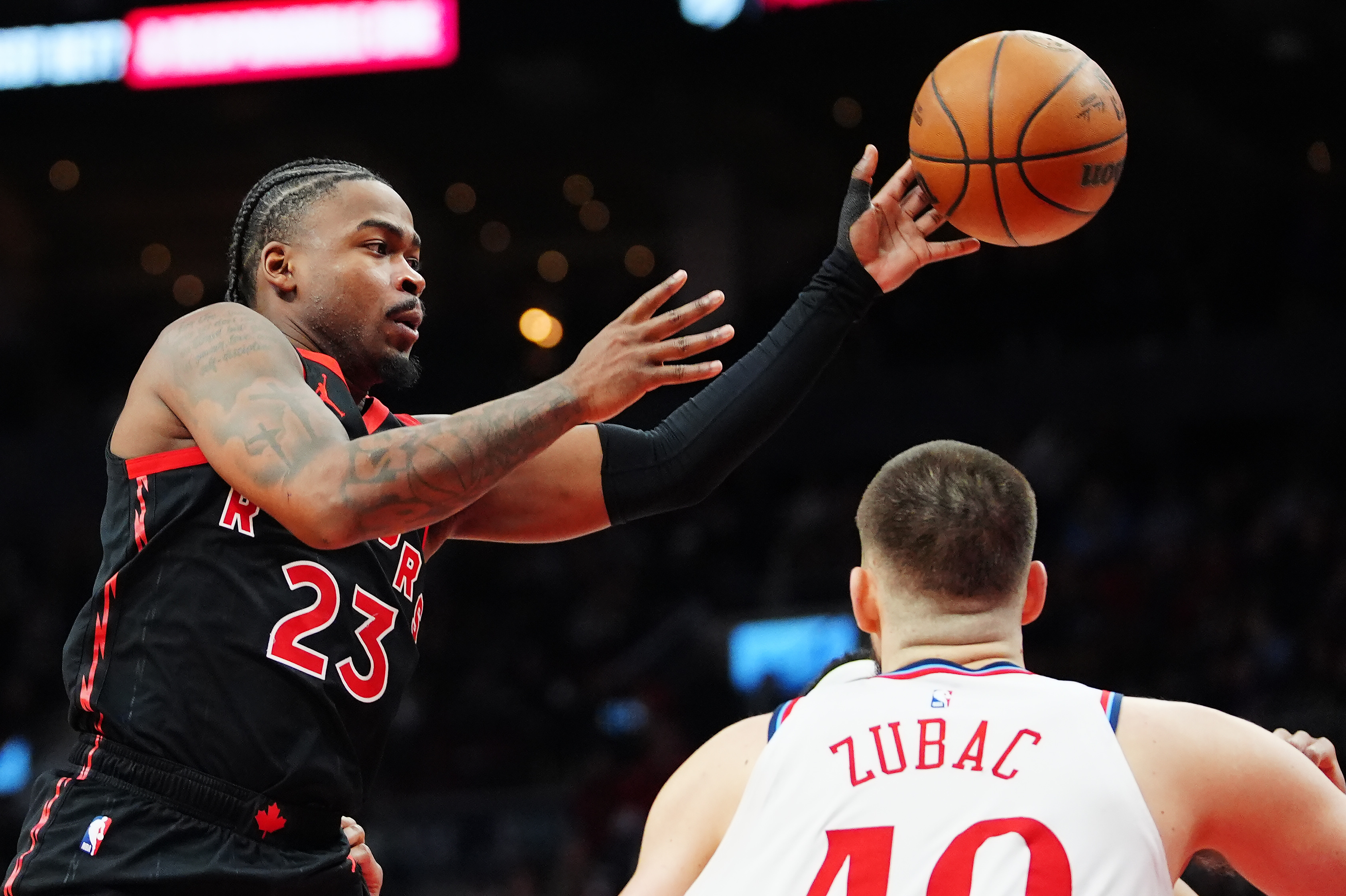 The Toronto Raptors’ Jamal Shead passes the ball as Clippers...