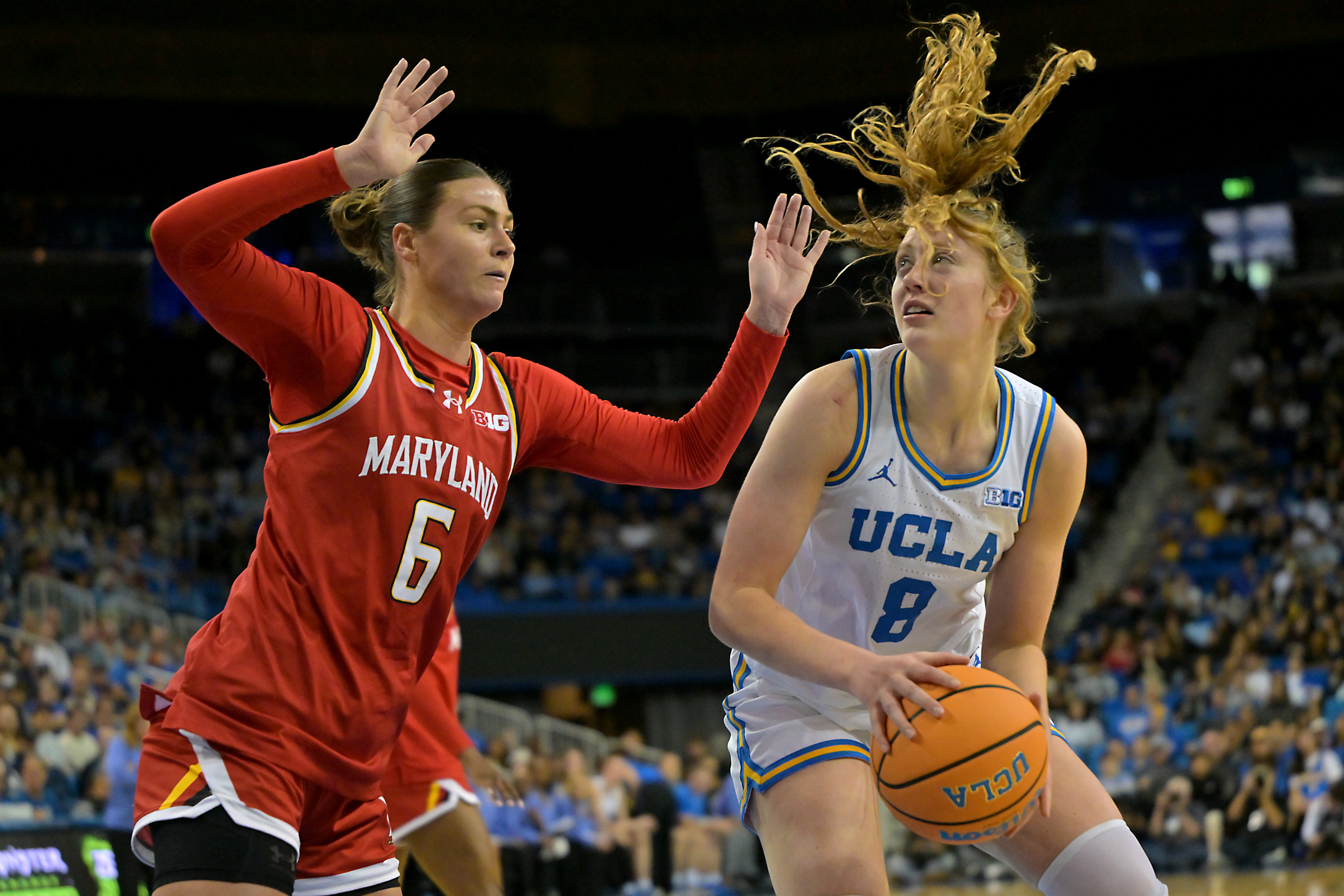 UCLA guard Gianna Kneepkens (8) is defended by Maryland guard...