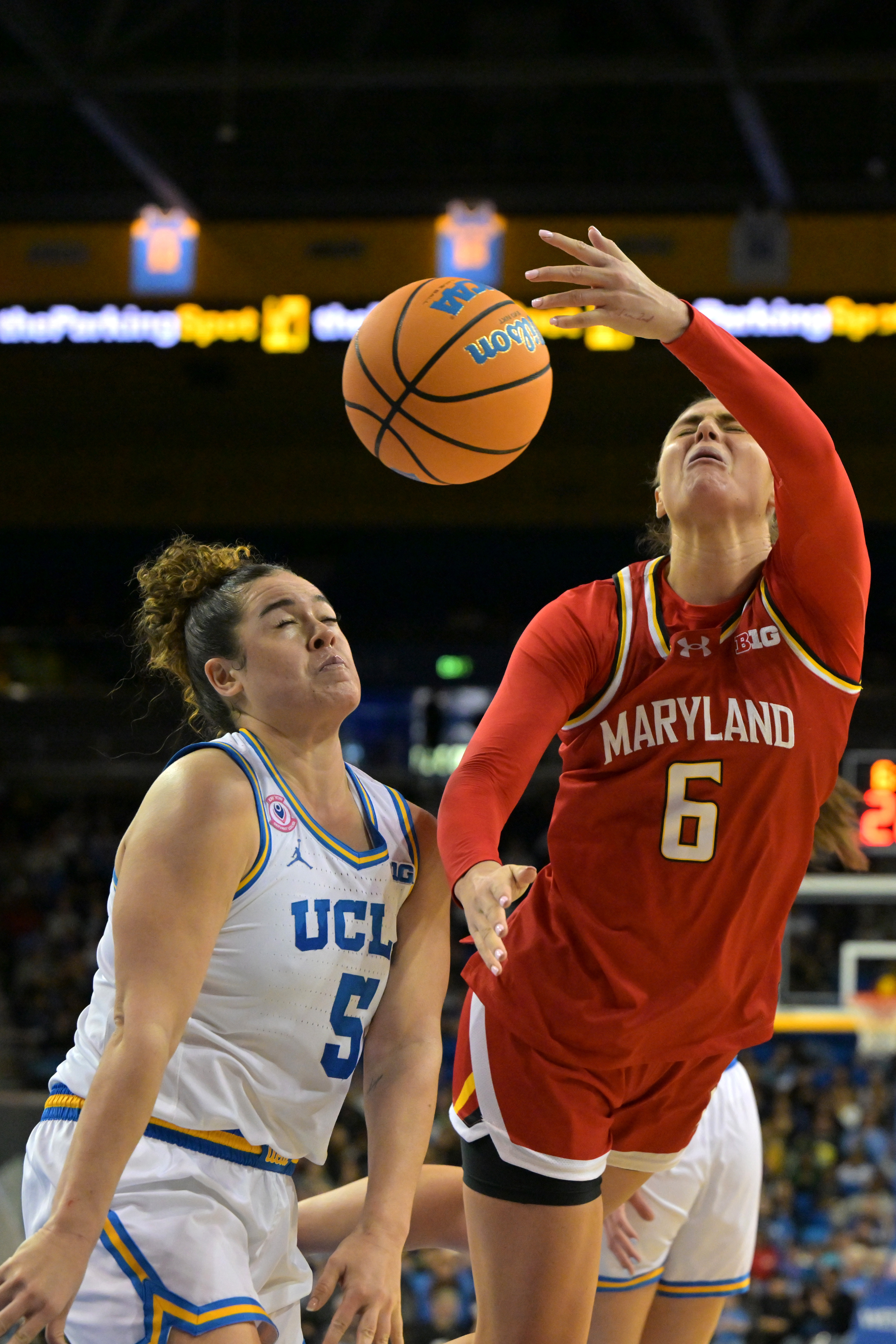 UCLA guard Charlisse Leger-Walker (5) fouls Maryland guard Saylor Poffenbarger...