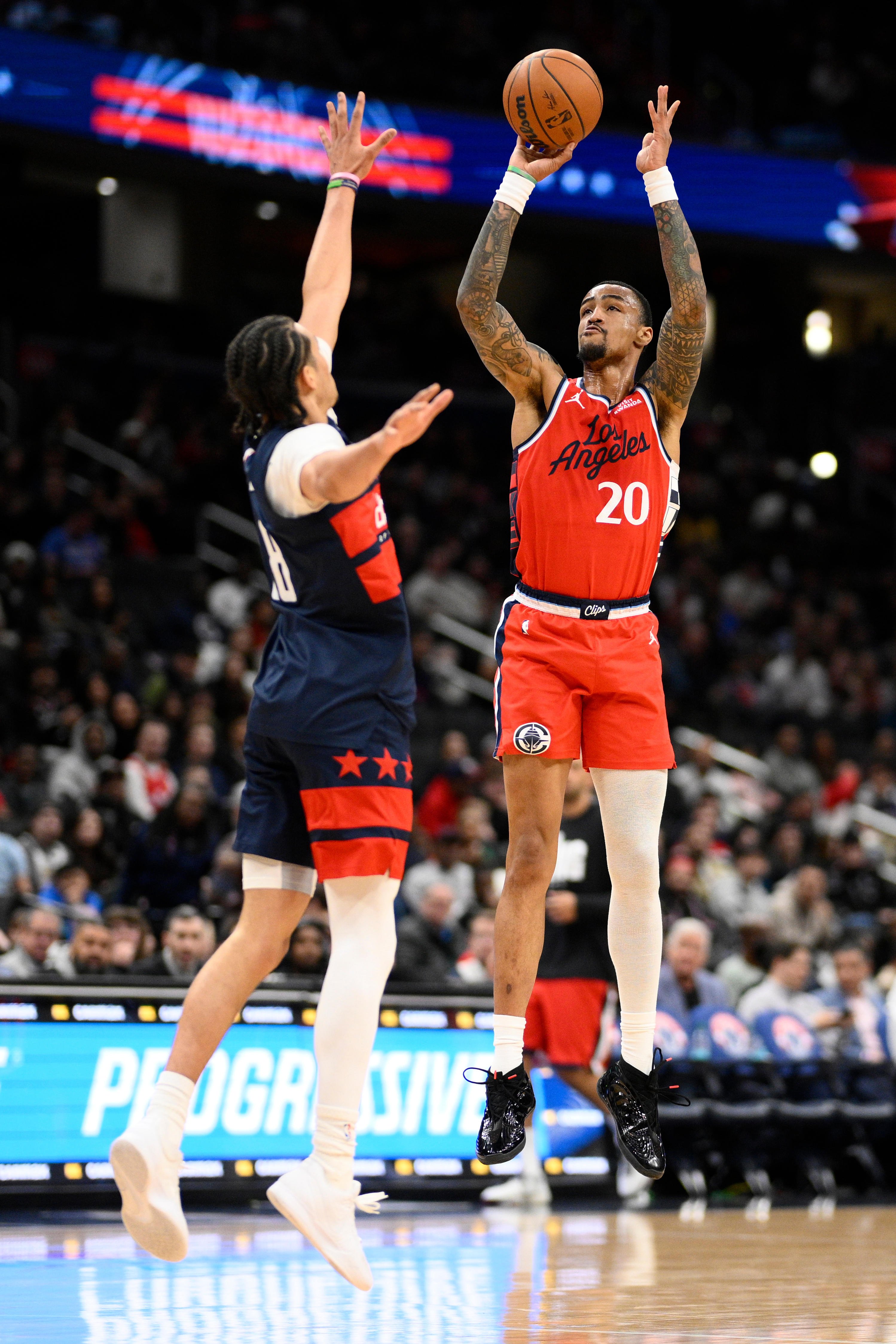 Clippers forward John Collins goes up to shoot as Washington...