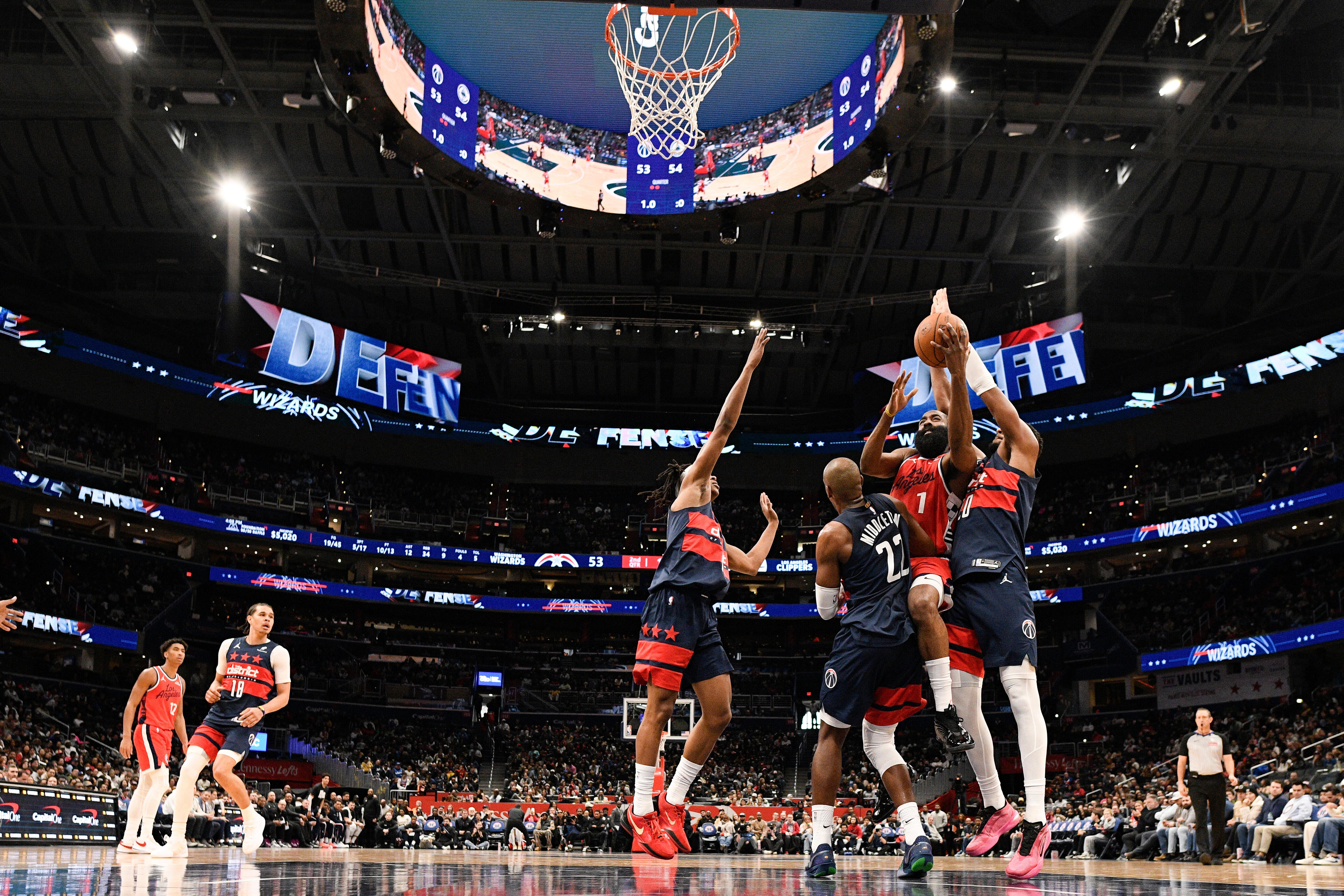 Clippers guard James Harden (1) goes to the basket as...